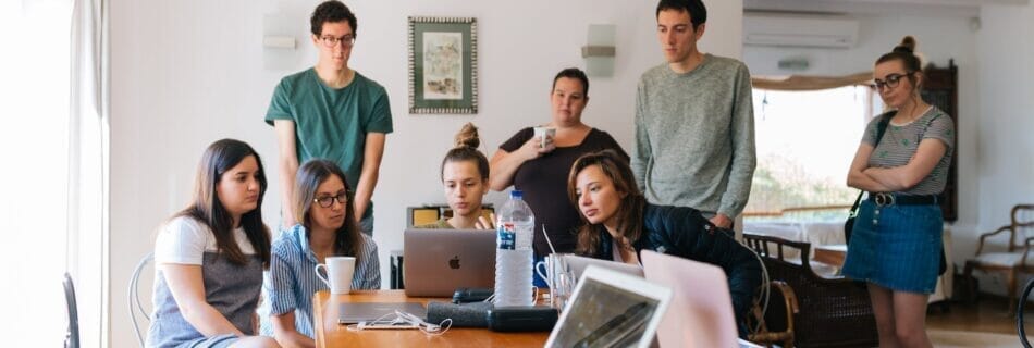 group of people watching on laptop