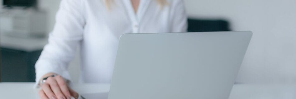 woman using silver laptop